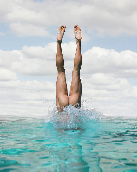 Girl jumps naked into pool photo