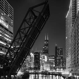 Kinzie Street railroad bridge at night in Black and White by Sebastian Musial