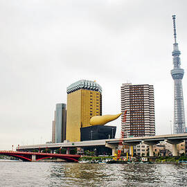 The Tokyo Skyline With A River In Front by Adam Hester