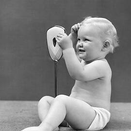1940s Blond Baby Girl Holding Vanity by Vintage Images