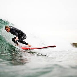 A Surfer Enjoys The Waves In Carlsbad by Jay Reilly