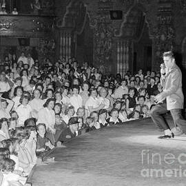 Elvis Presley in concert at the Fox Theater Detroit 1956 by The Harrington Collection