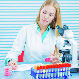 Lab Assistant Holding Sample