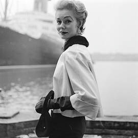 A Model Standing On A Dock In A Kidskin Jacket by Richard Rutledge