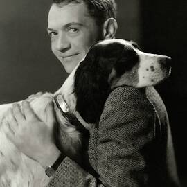 A Portrait Of John Held Jr. Hugging A Dog by Nickolas Muray