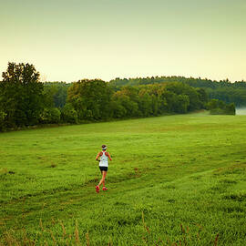 A Woman Running Through A Field by Josh Campbell