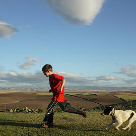 A Young Boy Runs Through An Open Field by Chris Butler