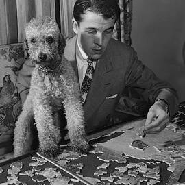 Alfred Gwynne Vanderbilt Completing A Puzzle by John Swope