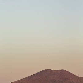 An Empty Two-lane Road Extends by David Hanson