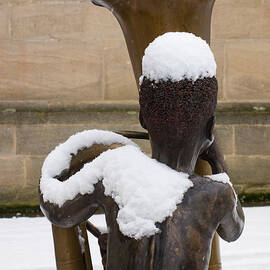 Bronze statue of a boy with a tuba by Matthias Hauser
