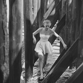 Catherine Murray Walking Through Wooden Pylons by Frances McLaughlin-Gill