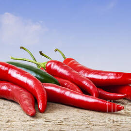 Chilli Peppers on Rustic Background by Colin and Linda McKie
