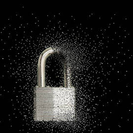 Close Up Of Padlock Dissolving by John M Lund Photography Inc