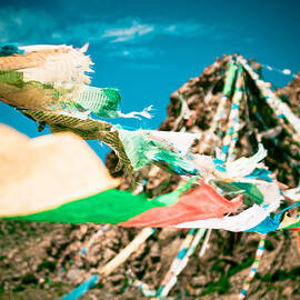 Colourfull praying buddhist flags lungta and mountain at background by Raimond Klavins