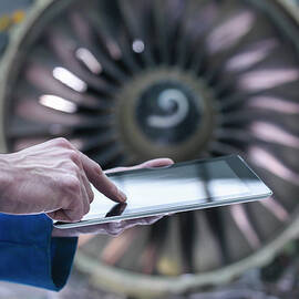 Engineer Using Digital Tablet In Front by Monty Rakusen