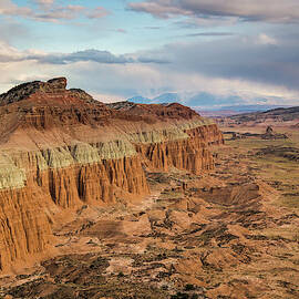 Eroded Cliffs Rise Above A Desert by Whit Richardson