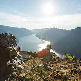 Female Hiker Relaxing At Top Of Mount by Matt Andrew