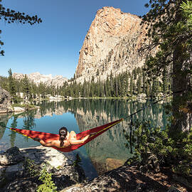 Female Hiker Relaxing In Hammock by Matt Andrew