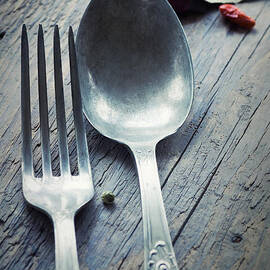 Fork and knife in rustic setting by Mythja Photography