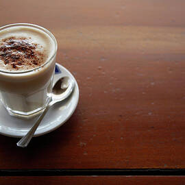 Fresh Latte Coffee On A Rustic Cafe by Andrew Bret Wallis