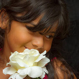 Girl smelling flower