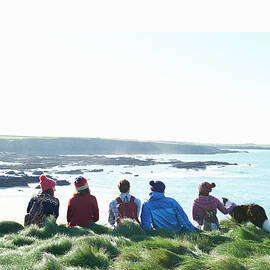 Group Of Students Sit And Look Along by Dougal Waters