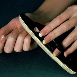 Hands Of A Model Using A Nail Buffer by William Connors