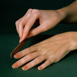 Hands Of A Model  Using An Emery Board by William Connors