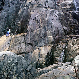 Hiker Explores The Coastal Cliffs by Peter Dennen