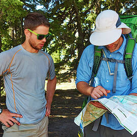 Hikers Checking The Trail Map by Josh Campbell