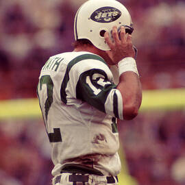 Joe Namath Fixing Helmet by Retro Images Archive