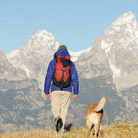 Man Backpacking With Dog In Grand Teton by Justin Bailie