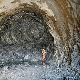 Man In A Tunnel Entrance by Science Photo Library