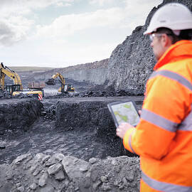Miner Checks Plans On Digital Tablet In by Monty Rakusen