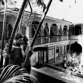 Models Posing On The Balcony Of A Building by Leonard Nones