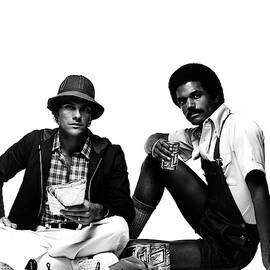 Models Wearing A Jacket And Overalls by Albert Watson