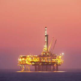 Oil Rig Platform In Twilight by Jimkruger