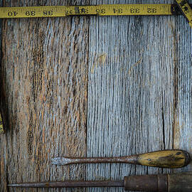 Old Tape Measure and Screwdriver for Construction on Rustic Wood by Brandon Bourdages