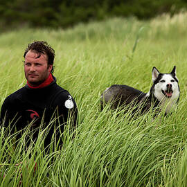 One Male Kiteboarder In A Wetsuit by Trevor Clark