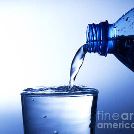 Pouring fresh water into a glass by Michal Bednarek