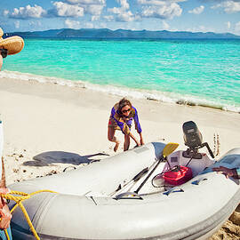 Pulling A Dinghy Up On The Beach by Tony Demin