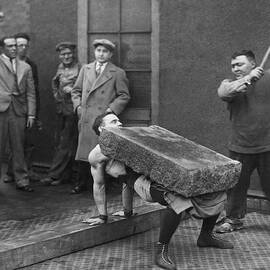 Rock Smashed On Man's Chest by Underwood Archives