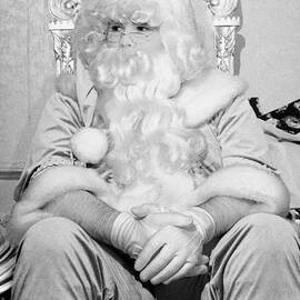 Santa sitting on his throne looking away from camera in grotto set up  by Joe Fox