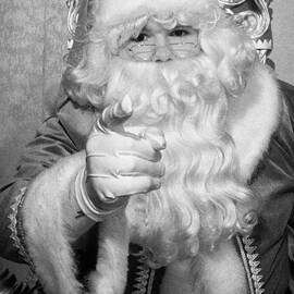 Santa sitting on his throne pointing to camera in grotto set up by Joe Fox