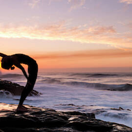 Silhouette Of A Woman Practicing Yoga by Panoramic Images