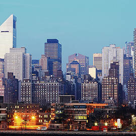 Skyline Of Manhattan Illuminated At by Allan Baxter