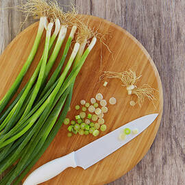 Spring Onions On Chopping Board by Colin Anderson Productions Pty Ltd