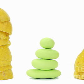 Squeezed yellow citrus and pebbles by Sami Sarkis Photography