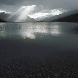 Sunrays Peering Through Clouds At Lake by Peter Essick