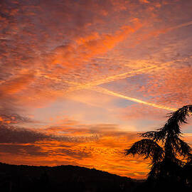 Sunrise with orange and red clouds in the sky by Matthias Hauser